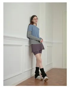 Close-up of black knitted wool blend leg warmers with sporty mini skirt and sneakers