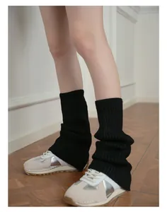 Detailed texture of black ribbed knit leg warmers with soft wool blend for Y2K style