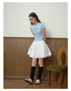 Detail of subculture black ballet knit leg warmers with casual sneakers and skirt