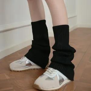 Y2K style black ribbed wool blend leg warmers styled with chunky platform sneakers