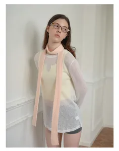 Detail of pink wool blend skinny scarf styled with a layered knit outfit