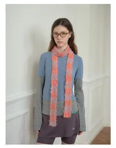 Fuzzy pink and orange striped knit scarf accessory on a vintage y2k style outfit