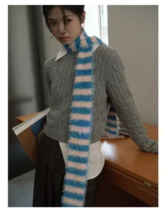 Detail of soft fuzzy knit scarf with vibrant blue and pink stripes in a college style