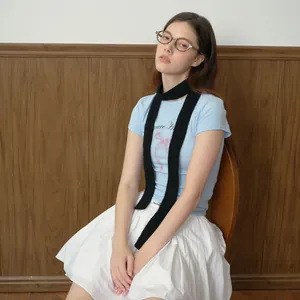 Slim black knitted wool blend scarf paired with a light blue bow graphic t-shirt