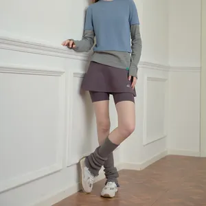 Subculture style outfit featuring blue layered top, purple skort, and knit leg warmers