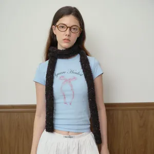 Blue bow t-shirt paired with a cozy dark brown speckled knit loop scarf for women