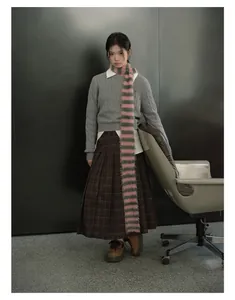 Pink and green striped faux mink scarf styled with a vintage plaid skirt and sweater