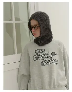Detailed texture of a grey wool blend balaclava hat with chunky knit pattern and cozy fabric