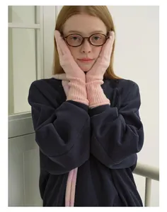 Detail of pink wool blend knit gloves with ribbed cuffs and soft thermal texture