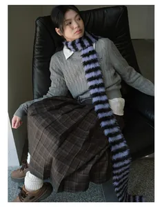 Detail of a vintage striped faux mink scarf styled with a grey knit and plaid skirt
