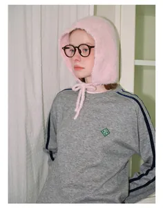 Detail of pink knitted plush balaclava with tie strings for winter warmth