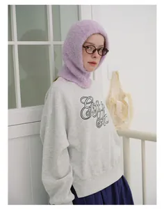Close-up of a cozy light purple knitted balaclava hood paired with a gray sweatshirt