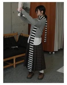 Detailed texture of black and white striped long faux fur scarf for winter warmth