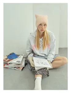 Pink knit cat ear beanie hat styled with a grey hoodie and trendy schoolgirl aesthetic