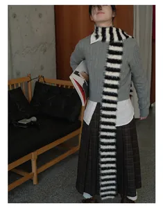 Detail of soft fuzzy black and white striped scarf styled with retro autumn outfit