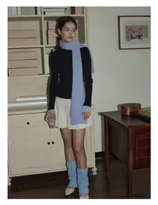 Detailed knit texture of light blue pure wool scarf paired with winter fashion outfit