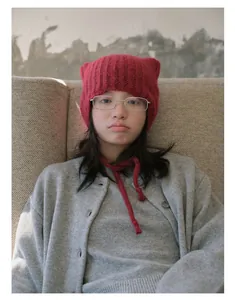Close-up of red alpaca wool blend cat-ear knit hat with adjustable chin straps