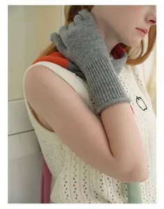 Detail of grey knitted arm warmer featuring soft ribbed texture and wool blend fabric