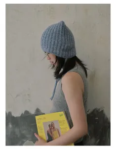 Detailed knit texture and tie strap of this light blue alpaca blend cat ear beanie hat