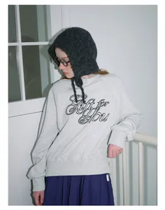 Detailed texture of dark grey fuzzy knit hood paired with a light grey sweatshirt