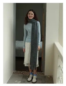 Deep grey wool blend scarf with tassels styled in a minimalist autumn winter outfit