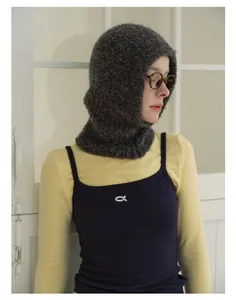 Detail of soft charcoal grey bouclé wool balaclava featuring plush knitted texture