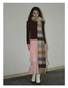 Macro shot of fluffy blue and beige checkered wool scarf styled with a layered pink skirt