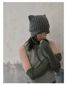 Detailed texture of charcoal grey knit cat ear hat with strap and matching arm warmers