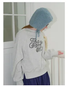 Detail of blue chunky knit balaclava with tie string for winter accessories