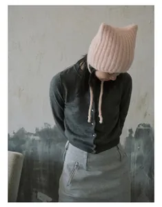 Pink alpaca-blend knit hat with cute cat ears and long ties shown on a female model