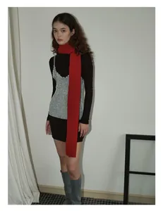 Detail view of the soft red wool knitted scarf with stylish winter layered outfit