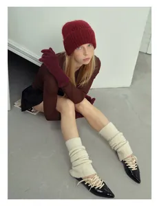 Detail of off-white ballet style wool blend leg warmers with slit knit texture