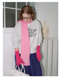 Detail of wool blend winter set featuring hot pink knit gloves and light pink scarf