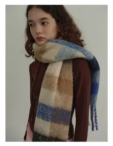 Close-up of wool plaid scarf with soft mohair texture and long decorative fringes