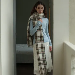 Plaid wool blend scarf with fringe worn over a white lace skirt for winter outfit