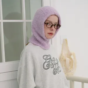 Soft purple wool blend balaclava knit hood worn with a grey sweatshirt in a cozy indoor setting
