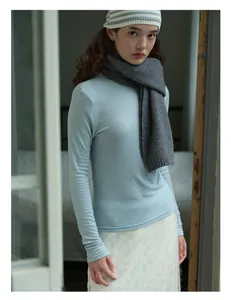 Detail of soft pale blue wool knit texture on a warm winter turtleneck sweater