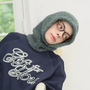 Winter grey wool blend balaclava hat with dark blue sweatshirt and stylish spectacles
