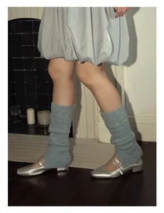 Detail of light blue wool blend balletcore leg warmers with textured knit and slit