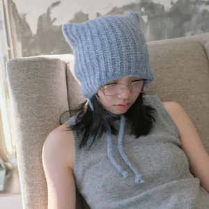 Light blue knit alpaca cat ear hat with long ties and soft ribbed texture for winter