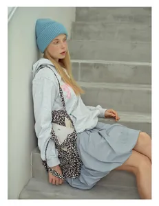 Chic blue wool knit beanie styled with a leopard print tote bag and gray hoodie outfit