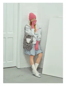Winter outfit featuring a pink knitted wool beanie, bow sweatshirt and leopard print tote bag