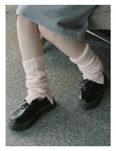Detailed view of pink wool blend leg warmers with side slits and rib knit texture