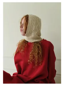 Detail of aran knit wool balaclava featuring chunky cable pattern and ribbed texture