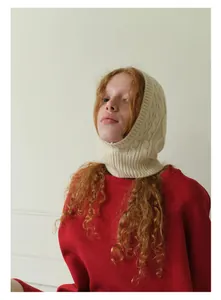 Detail of off-white cable knit balaclava hood showing wool blend texture and warmth