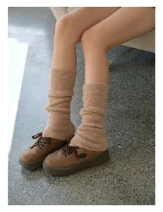 Detailed knit texture of brown wool blend slouchy leg warmers paired with platform shoes