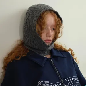 Grey cable knit wool balaclava hood scarf shown on a model in a minimalist style
