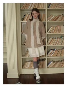 Detail showing plush wool blend long scarf styled with a brown top and lace skirt