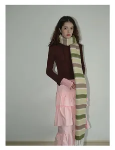 Détail d'écharpe en laine mélangée à rayures avec une jupe à volants rose