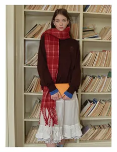 Detail of red and white checkered wool blend scarf styled with a dark sweatshirt